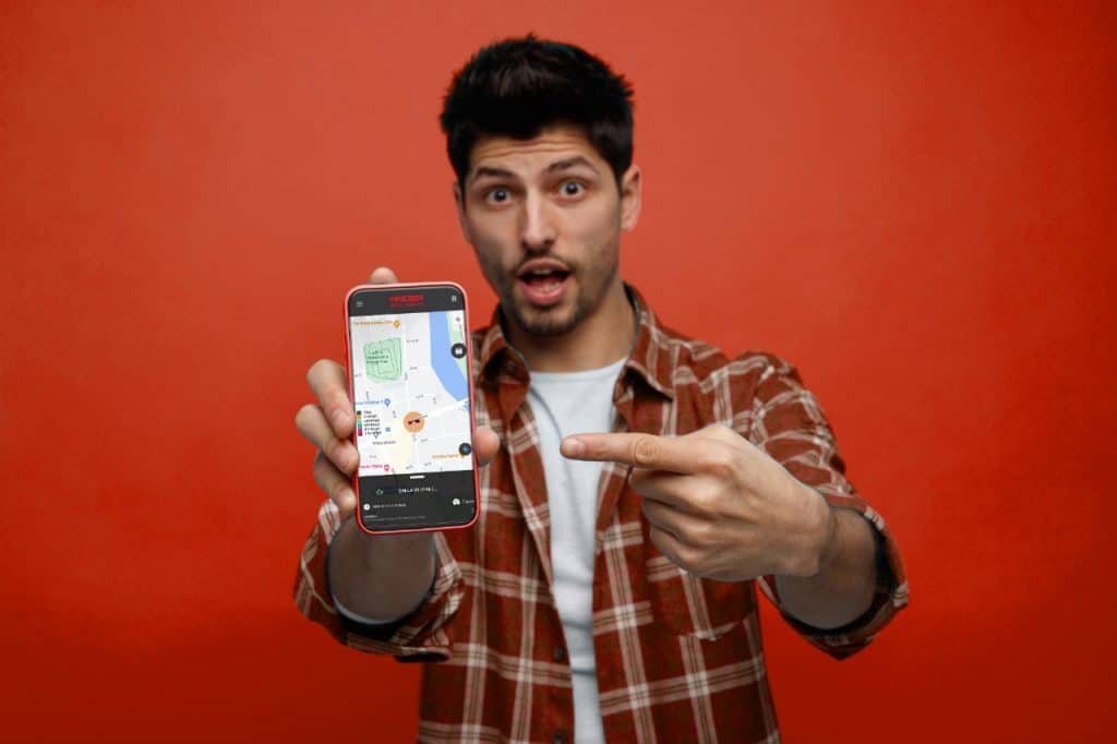 Man showing GPS tracking app on smartphone with map interface.
